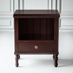 a small wooden cabinet sitting on top of a white floor