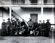 an old black and white photo of people in front of a building