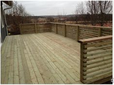 a wooden deck with railings and rails