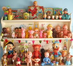 a shelf filled with lots of toys and figurines on top of each other