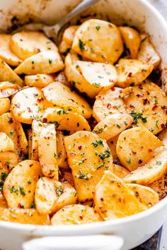 a casserole dish with potatoes and parsley