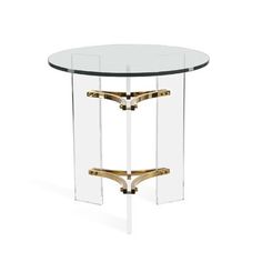 a round glass table with gold metal legs