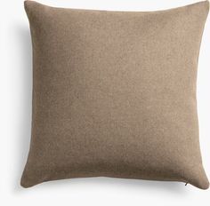 a brown pillow sitting on top of a white wall