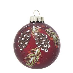 a red ornament with pine cones and snowflakes on it's side