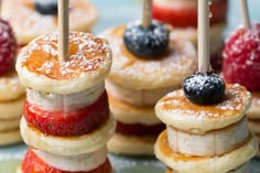 small pancakes with strawberries and blueberries on them