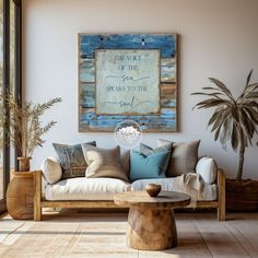 a living room with a couch, table and potted plant on the side wall