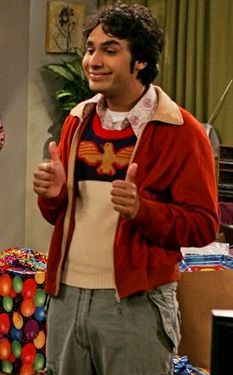 a man giving the thumbs up while standing in front of a table with presents on it