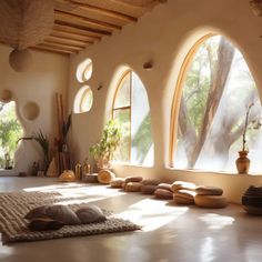 a room with arched windows and rugs on the floor