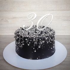 a black and white cake with the number 30 on it