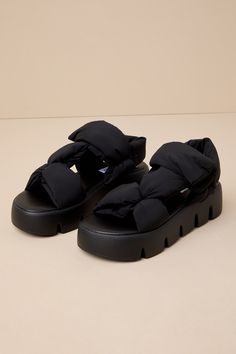 It's easy to make a stylish statement on the daily when you have the Steve Madden Xandria Black Puffer Flatform Sandals! These chunky sandals feature smooth, quilted fabric puffer straps that shapes a sporty silhouette with a rounded footbed and an adjustable VELCRO ; ankle strap. The lightweight, wide treaded flatform sole completes the fashion-forward look! 1. 5" flatform sole. Cushioned insole. Rubber sole has nonskid markings. Man Made Materials. Imported. Lulus | Xandria Black Puffer Flatfo Spring Open Toe Nylon Sport Sandals, Spring Nylon Sport Sandals With Open Toe, Spring Nylon Open Toe Sport Sandals, Spring Open Toe Nylon Sandals, Spring Nylon Open Toe Sandals, Black Nylon Sandals, Spring Cushioned Nylon Sandals, Casual Nylon Sandals For Spring, Comfortable Open Toe Nylon Sandals