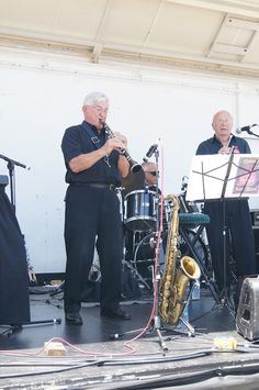 two men are playing instruments on stage