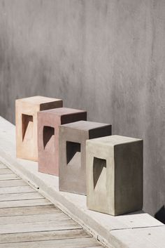 three different colored concrete blocks sitting next to each other