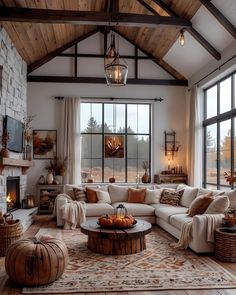 a living room filled with lots of furniture next to a fire place and large windows