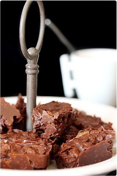 a white plate topped with pieces of chocolate