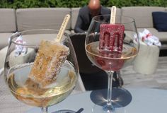 two wine glasses filled with different types of desserts and pastries on a table