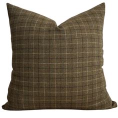 a brown plaid pillow on a white background