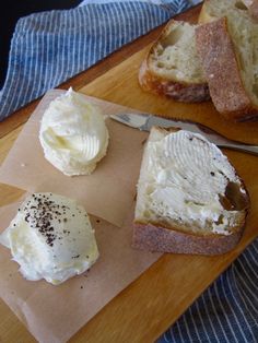 two slices of bread with whipped cream on them and a knife sitting next to it