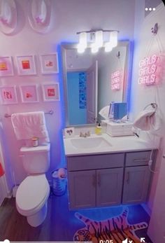 the bathroom is decorated in pink, blue and white with zebra rugs on the floor