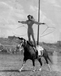 an old photo of a woman on top of a horse with a lasso in her hand