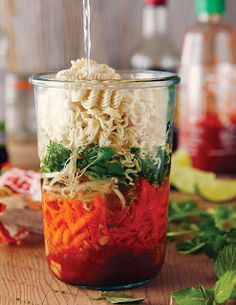 a jar filled with food sitting on top of a wooden table