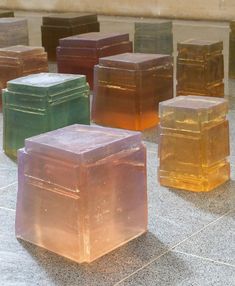 there are many different colored cubes sitting on the ground in front of each other