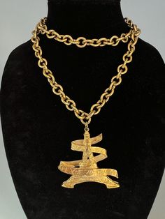 WOW!! Rare and collectible vintage Givenchy Eiffel Tower pendant necklace with script logo "Givenchy Paris". The large 2"x2.25" gold plated pendant hangs from a 34-inch chunky oval link chain. This piece is substantial! Nice vintage condition with some plate loss on bottom of tower pendant, although not noticeable when worn. This is a WONDERFUL piece of designer vintage! Please Note: All of these items are vintage. They have been pre-loved and are not in pristine condition. I try to take photos of any areas of concern. Please ask for more photos if you have any concerns about the condition of a piece. Returns will only be accepted if there is damage in shipping. Vintage Givenchy, Givenchy Paris, Script Logo, Funky Jewelry, Designer Vintage, Link Chain, Birmingham, More Photos, Pendant Necklaces