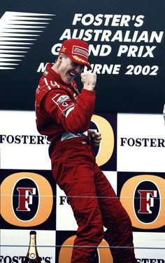 a man standing on top of a podium holding his fist up