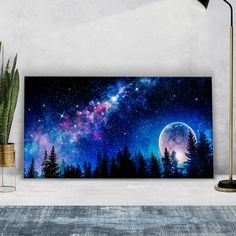 the night sky with stars and trees in front of a large painting on a wall