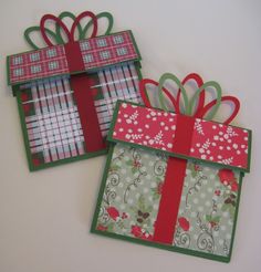 two gift boxes with bows and ribbons on them, one is green and the other is red