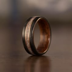 a wooden ring with black and brown wood inlays