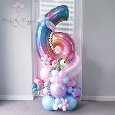 a balloon shaped number with unicorns and balloons