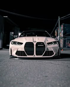 a white car parked on the street at night