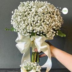 a bouquet of baby's breath is being held by someone