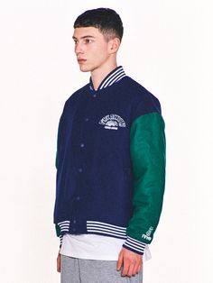 Editor's Notes Featuring various embroidered logo graphics, this casual varsity jacket is made from wool-blend with lightly padded lining for warmth. It's constructed with classic color-blocking body and sleeves with sporty striped ribbed edges.- Snap button fastenings- Two front welt pockets- Logo embroidery on the chest, sleeve and back- Logo labels on the hem and back- Striped ribbed edges- Drop shoulder- Relaxed fitMeasurements (in.) 2 / 3- Total Length: 26.0 in. / 27.2 in. - Shoulder: 22.8 in. / 24.4 in.- Chest: 25.2 in. / 26.8 in.- Sleeve Length: 22.8 in. / 23.6 in.Model info: 5' 11.7, 132.3 lbs / Fitting size 3Composition & Care- Shell: 50% Acrylic, 50% Wool- Lining: 100% Polyester- Filling: 100% Polyester- Dry clean only- Refer to the care labelDesigner- by FREAKISH BUILDING Cotton Varsity Jacket With Patchwork And Baseball Collar, Winter Varsity Jacket With Patchwork And Baseball Collar, Fall Varsity Jacket For Campus, Casual Outerwear With Contrast Color For College, Casual Contrast Color Outerwear For College, Casual College Outerwear With Contrast Color, Cotton Varsity Jacket With Letter Patch For Streetwear, Varsity Jacket With Letter Patch And Long Sleeves, Varsity Style Long Sleeve Outerwear With Contrast Color