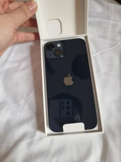 someone is holding an iphone case in their hand and it's inside the box