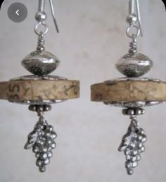 the earrings are made out of silver and wood