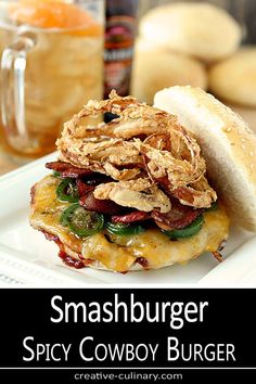 a close up of a sandwich on a plate with text overlay that reads smashburger spicy cowboy burger