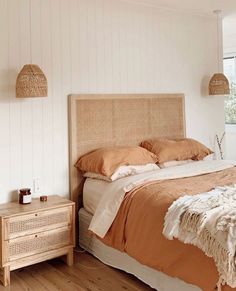 a bed sitting in a bedroom next to a wooden dresser and lamp on top of a hard wood floor