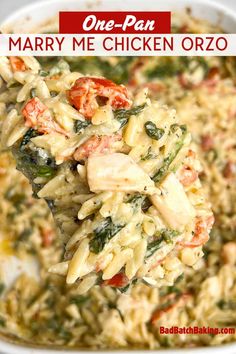 a close up of a spoon full of chicken orzoni casserole with tomatoes and spinach