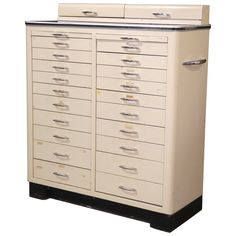 an old white filing cabinet with many drawers