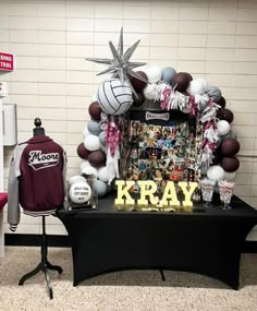 a table topped with balloons and sports memorabilia