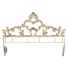 an ornate gold headboard is shown against a white background