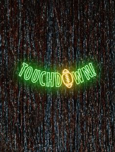 a neon sign that says touchdown on it