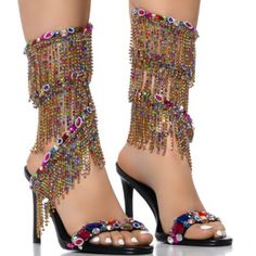 There’s Nothing Strange About Our Love For The Azalea Wang " Cascaded Gems " Embellished Sandal In Multi. These Glitzy Sandals Feature A Faux Leather Upper, An Open Almond Toe Silhouette, A Cushioned Faux Leather Insole, And A Slim Stiletto Heel. Complete With A Gemstone-Embellished Foot Band And A Coordinating, Rhinestone Link Fringe Trim Coiled Ankle Band. Pair With Distressed Denim For A Dose Of Casual Cool. - Faux Leather Upper - Open Almond Toe - Stiletto Heel - 3.75” Heel Height - 4.5” Spi Beaded Heels For Party, Multicolor High Heel Sandals With Rhinestones, Party Open Toe Sandals With Tassels, Party Sandals With Tassels And Open Toe, Multicolor Rhinestone High Heel Sandals, Summer Evening Heels With Tassels, Beaded Heels For Evening In Summer, Beaded Heels For Evening Summer Occasions, Summer Evening Beaded Heels