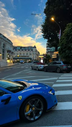 a blue sports car is parked on the street