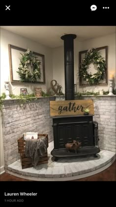 an image of a fireplace in the middle of a room with wreaths on it