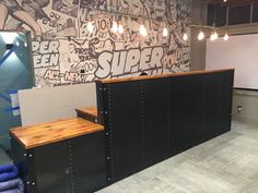 an office with comic themed walls and wood counter tops