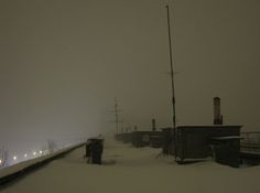 the train tracks are covered in snow as it passes through an area with power lines