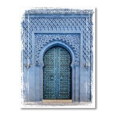 an ornate blue door in the middle of a building with intricate carvings on it's sides