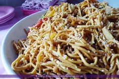 a white plate topped with pasta and vegetables